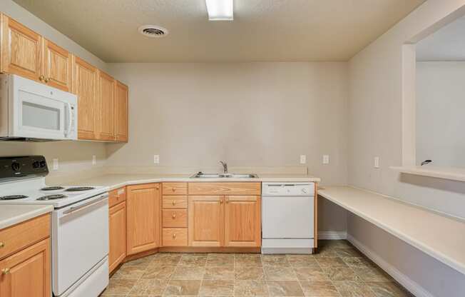 a kitchen with white appliances and wooden cabinets