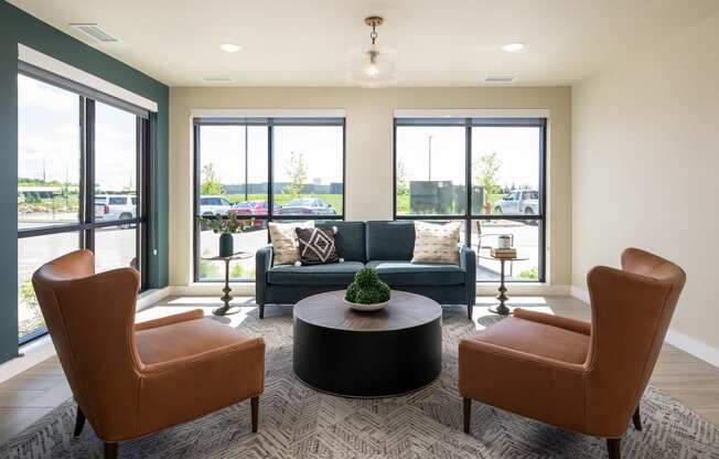 a living room with a couch and chairs and a table