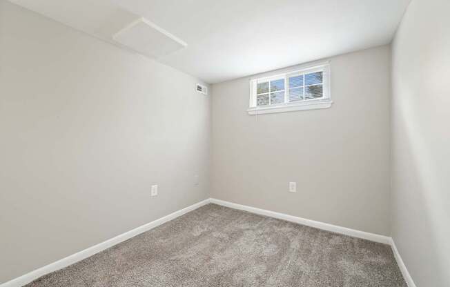 an empty room with carpet and a window at ReNew Odenton