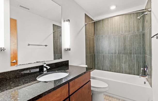 A bathroom with a sink, toilet, and bathtub.