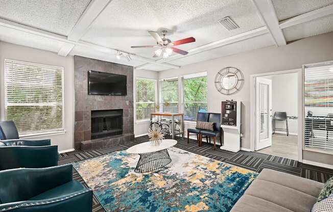 a living room with a fireplace and a ceiling fan