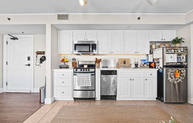 a kitchen with stainless steel appliances and white cabinets