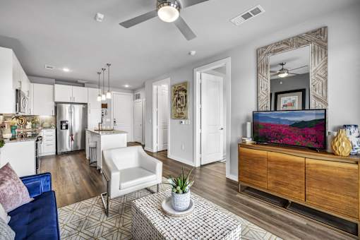 A modern living room with a white sofa and a wooden coffee table.