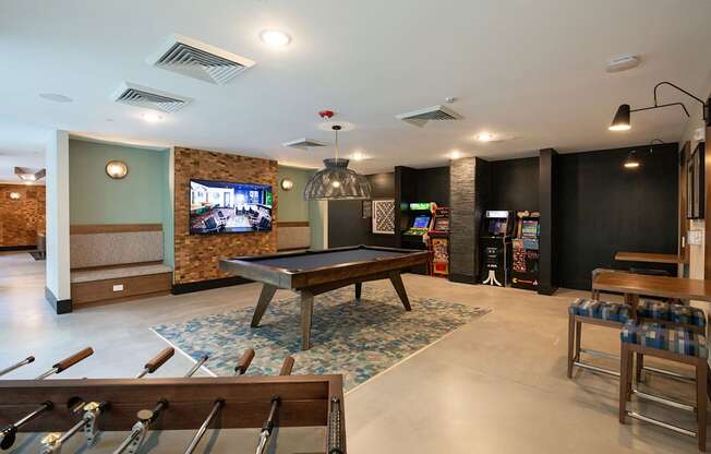 a game room with a pool table and a tv