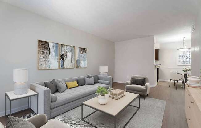 A living room with a grey couch, a coffee table, and a lamp.