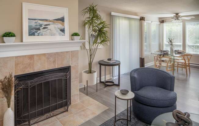 a living room with a fireplace and a table with chairs