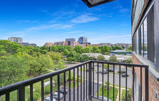 the view of the city from the balcony of an apartment building with a balcony railing