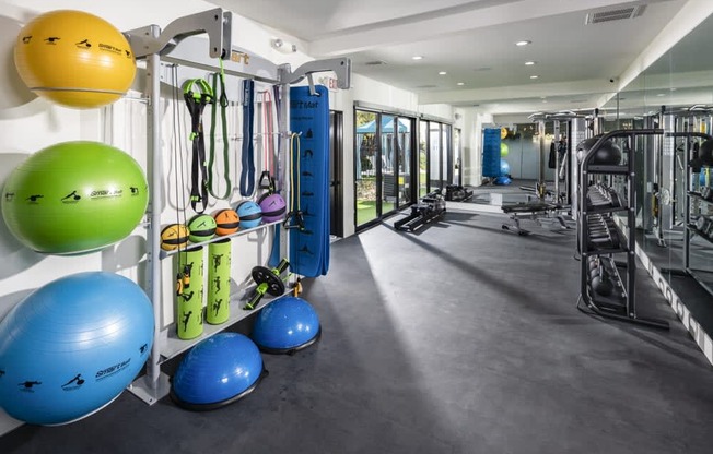 a workout room with weights and other exercise equipment