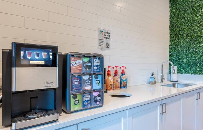 A coffee machine and a box of milk are on a counter.