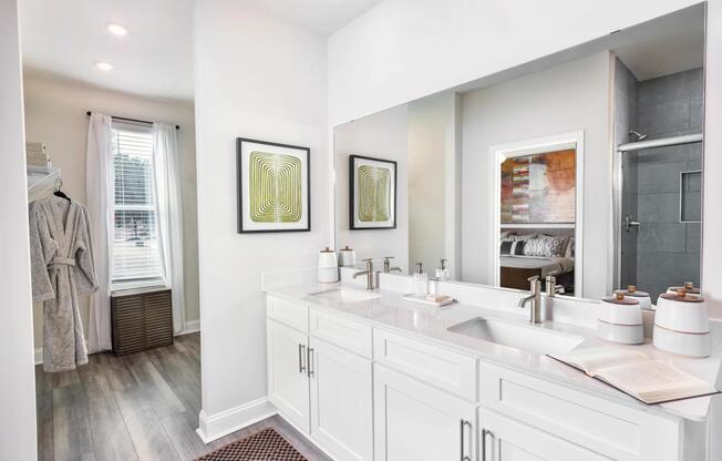 Designer bathrooms feature double vanities, quartz countertops, and large mirrors, all crafted for your ultimate relaxation and style at Amavi Brier Creek. Add to Discover > Amenities: Designer bathrooms with double vanities, quartz countertops, and large mirrors.