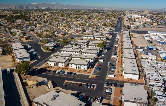 an aerial view of a city with a mountain range in the background