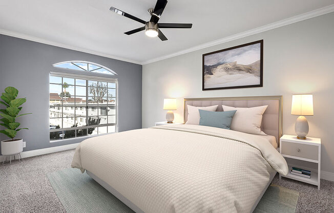 Carpeted bedroom featuring beautiful natural lighting and ceiling fan.