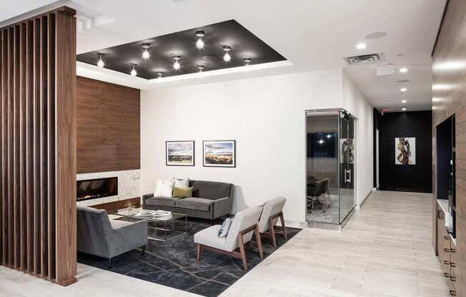 Cozy and sleek fireplace lounge in the lobby with white walls.