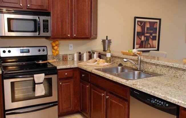 upgraded kitchen with granite countertops at Metropolitan Collection Apartments, Renton, 98057