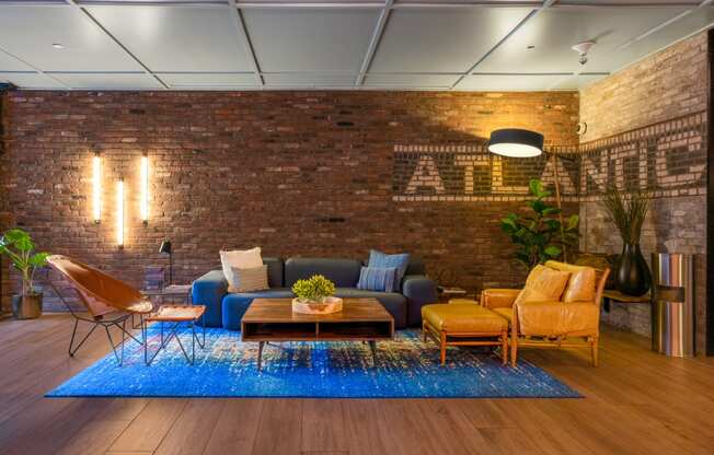 a living room with a brick wall and a blue rug