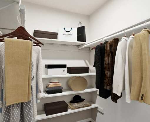 a walk in closet with white shelves and a white hanger  at Lake Johnson Mews, North Carolina, 27606