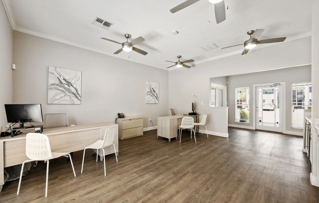 Bright and welcoming office space with modern desks, elegant flooring, and stylish ceiling fans, perfect for productive workdays.