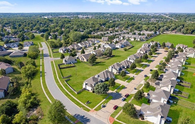 an aerial view of a neighborhood with houses and lawns