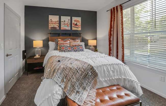 a bedroom with a bed and a window