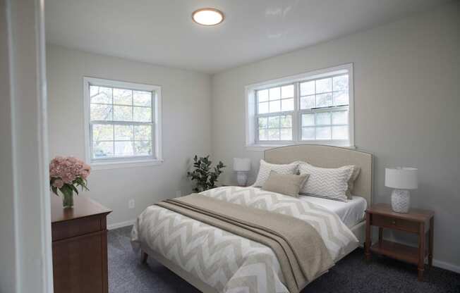 a bedroom with a bed and two windows  at Venue at Carrollton, Georgia