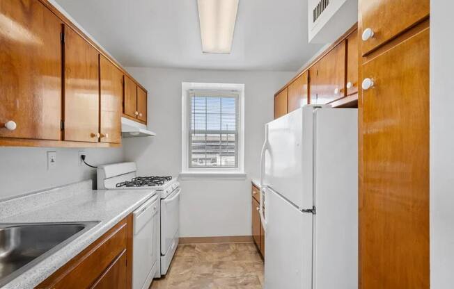 Rich wood cabinets and a gas stove