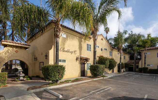 A building with a palm tree in front of it.
