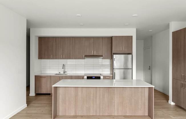 A modern kitchen with wooden cabinets and a white countertop.