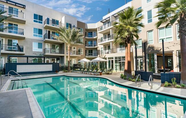 Modera Pomona features a tranquil, resort-style pool with a relaxing lounge area.