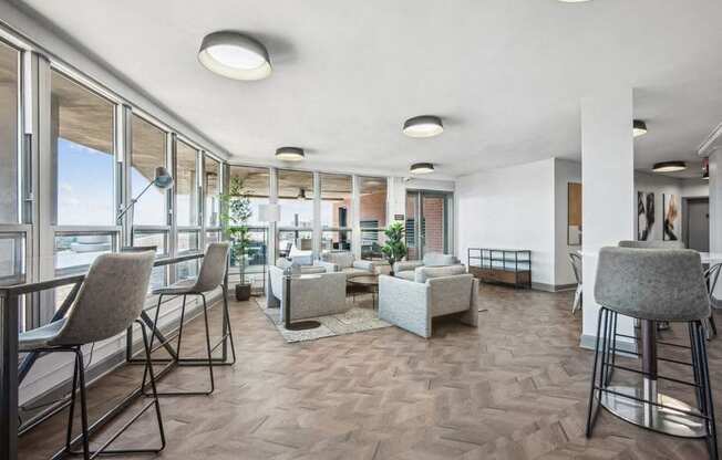 a living room with tables and chairs and a balcony