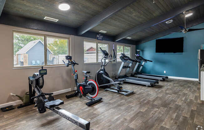 A spacious home gym with a variety of exercise equipment.