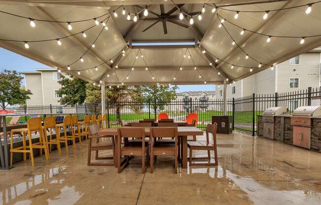 a patio with a table and chairs under a canopy