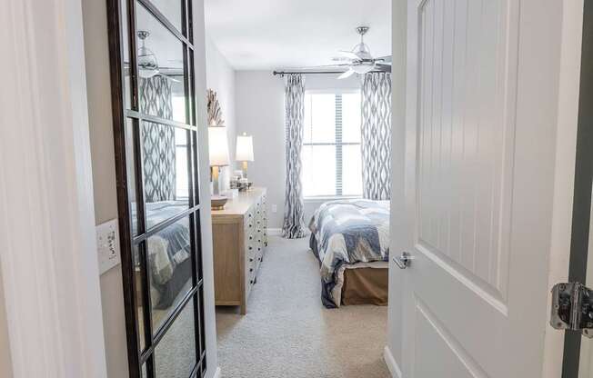 A bedroom with two beds and a ceiling fan.