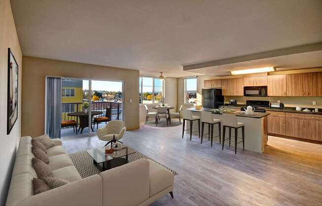 A modern living room with a large couch and a kitchen area in the background.