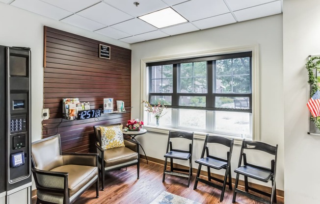 a dining room with a table and chairs and a large window