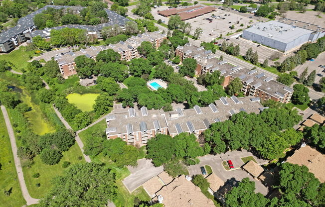An aerial view of a residential area with a swimming pool.