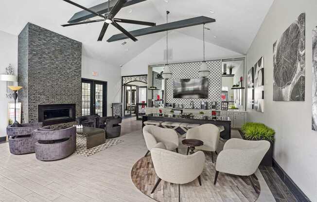 A modern living room with a stone fireplace and a large fan.