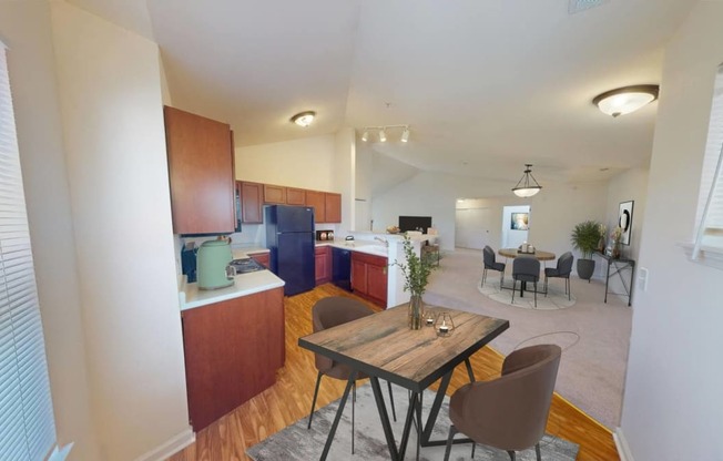 a kitchen and dining room with a table and chairs