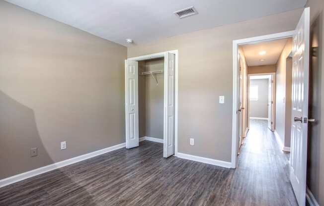 the living room and hallway of a new home with wood flooring