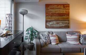 a living room with a couch and a painting on the wall