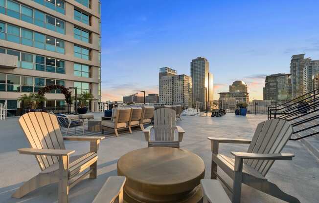 a large patio with rocking chairs and a view of the city