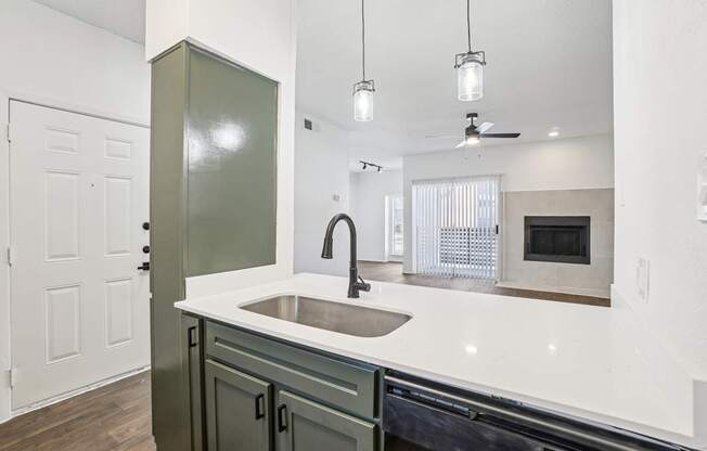 A kitchen with a sink and a green cabinet.