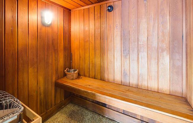 Wood panneled sauna with a bench
