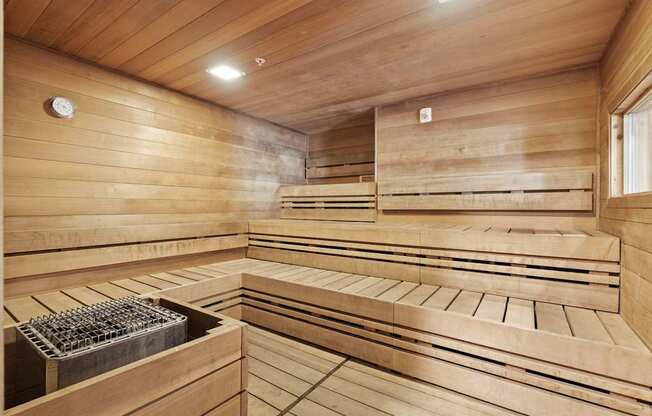 a sauna with wooden walls and benches and a window