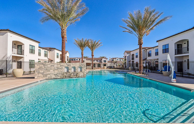 our apartments have a large swimming pool with palm trees at Stella Luxury Apartment Homes, San Tan Valley, AZ, 85143