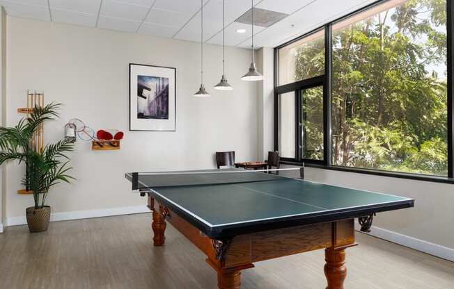 a game room with a pool table and a large window