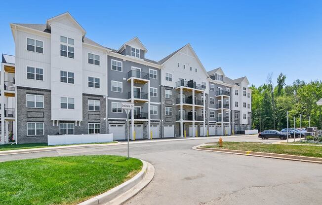 an empty street in front of an apartment building