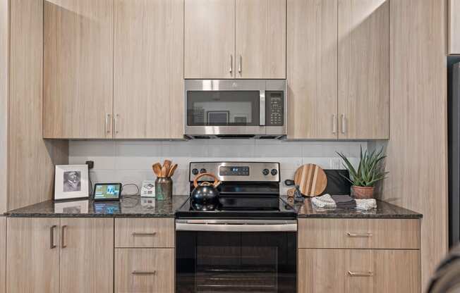 a kitchen with wooden cabinets and a stove and a microwave