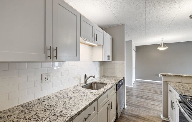 a kitchen with white cabinets and a sink at Troy Place Apartments - Troy, MI, Troy
