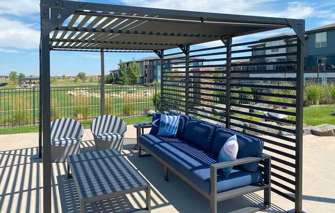 A blue and white striped cushion is on a blue and white striped bench.