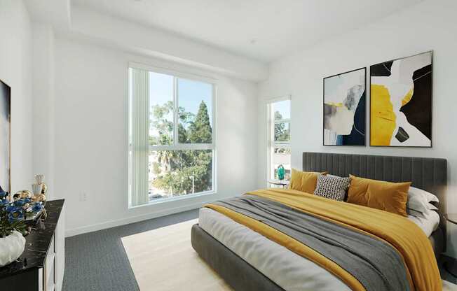 A bedroom with a large bed and a painting on the wall.